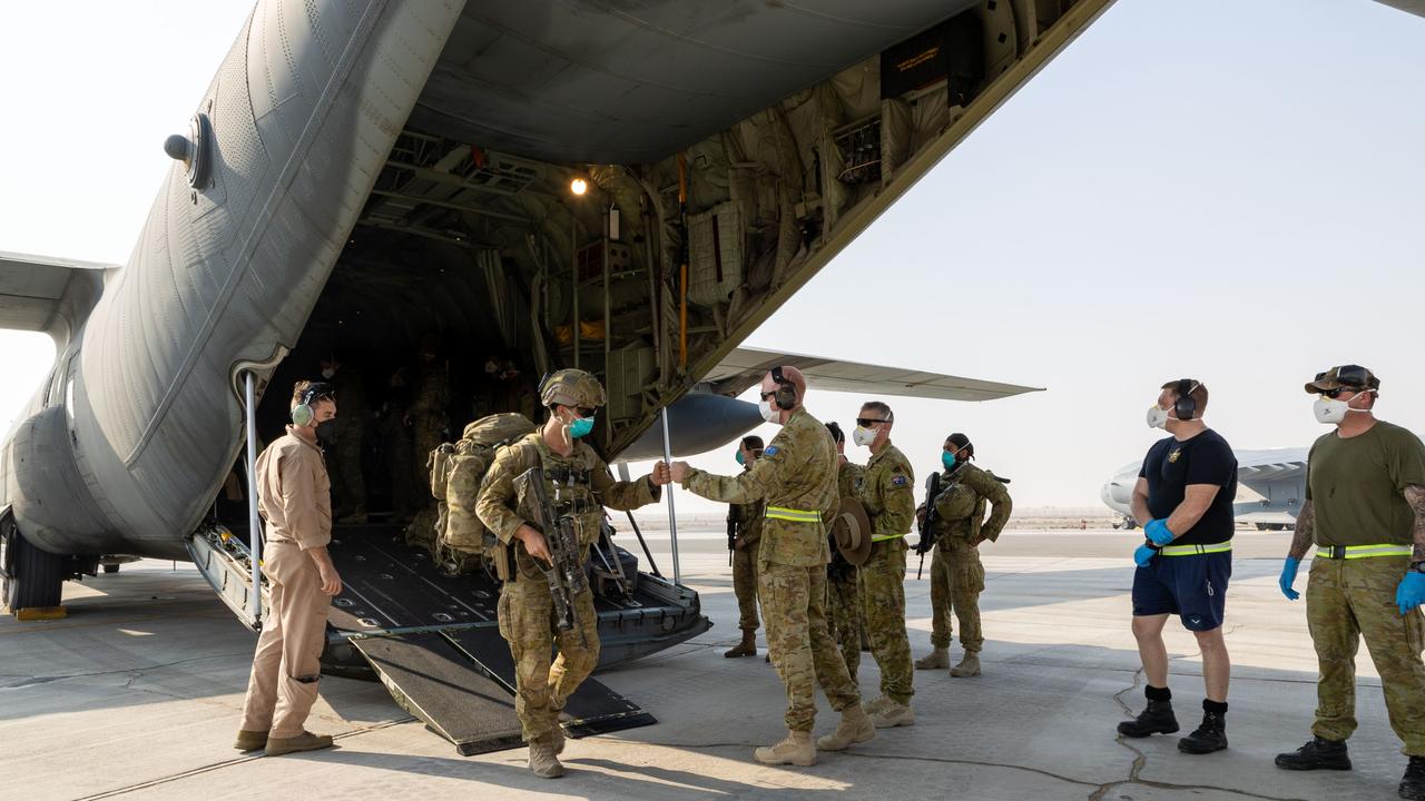 Commander Joint Task Force 633 Air Commodore David Paddison CSC, welcomes soldiers from the 1st Battalion, Royal Australian Regiment, as they disembark a Royal Australian Air Force C-130J Hercules aircraft at Australia's main operating base in the Middle East region, after their flight from Kabul, Afghanistan.