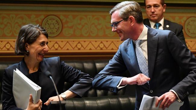 Gladys Berejiklian bumps elbows with NSW Treasurer Dominic Perrottet after he delivered the NSW State Budget last Tuesday, November 17 — the day she was tested for COVID-19. Picture: AAP