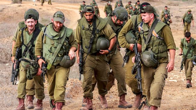 Israeli army soldiers return after searching for human remains following the October 7 attack carried out by Palestinian militants from the Gaza Strip, near a position along the border with southern Israel. Picture: AFP