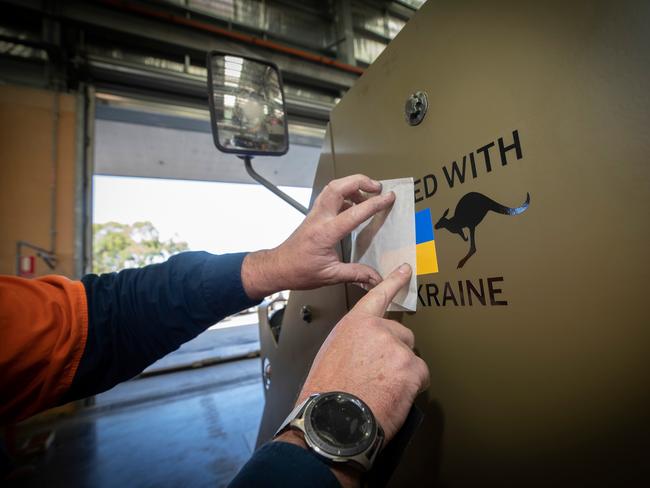 The "United with Ukraine" decal is applied onto the first of fourteen M113AS4 Armoured Personnel Carriers bound for Ukraine at Joint Logistics Unit â South Queensland, RAAF Base Amberley. *** Local Caption *** At the request of the Government of Ukraine, Australia has agreed to provide further defensive capability to protect Ukrainian soldiers and support Ukraineâs response to Russiaâs unrelenting and illegal aggression, even as Russia suffers set-backs. At the request of the Government of Ukraine, is gifting 14 M113AS4 Armoured Personnel Carriers and 20 more Bushmaster Protected Mobility Vehicles. Coming from current ADF stocks, the M113AS4 Armoured Personnel Carrier is a longstanding in-service ADF armoured fighting vehicle, and along with the Bushmaster Protected Mobility Vehicle, provides Ukrainian forces with a proven and effective capability to transport infantry soldiers on the battlefield. The gifted vehicles also join 60 pallets of medical supplies donated by Australian citizens and radiation monitoring radiation monitoring equipment and personal protective equipment, and personal protective equipment. Australiaâs current support to the Government of Ukraine has included the gifting of six M777 155mm lightweight towed howitzers plus ammunition, 20 Bushmaster Protected Mobility Vehicles, including 14 Protected Weapons Systems; anti-armour weapons and ammunition, body armour and cold weather clothing, combat rations, medical supplies and financial contributions to NATOâs trust fund for the Ukraine.