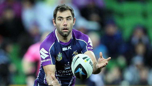 Former Logan Brothers player Cameron Smith offloads the ball during the round 18 NRL match between the Melbourne Storm and the Canterbury Bulldogs earlier this month. Picture: Robert Prezioso, Getty Images.