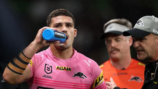 MELBOURNE, AUSTRALIA - MARCH 20: Nathan Cleary of the Panthers is assisted off the field by a trainer for a Head Injury Assessment (HIA) during the round three NRL match between the Melbourne Storm and Penrith Panthers at AAMI Park on March 20, 2025, in Melbourne, Australia. (Photo by Daniel Pockett/Getty Images)