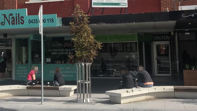 People stopped to drink coffee and chat in the sunshine at Mentone.