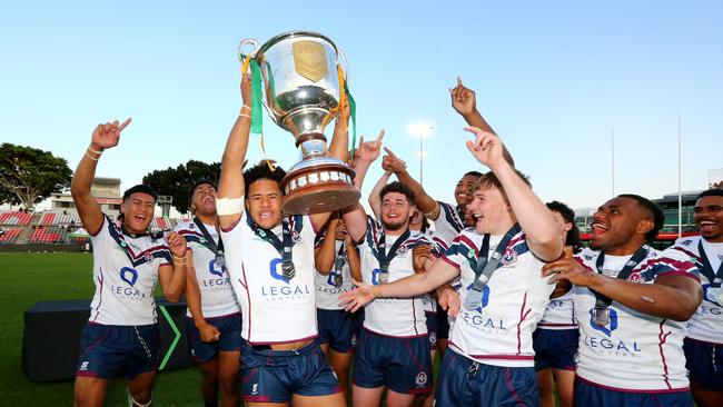 Ipswich Captain Josiah Pahulu holding the National Schoolboys Trophy.