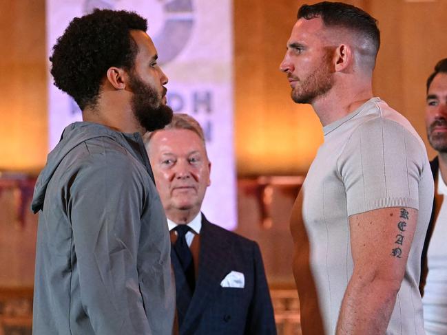 British Slovakian Boxer Moses Itauma (L) and Australian boxer Demsey McKean challenge each other during a press conference, in central London, on October 23, 2024, ahead of their  heavyweight undercard fight, taking place on December 21, 2024 in Riyadh, Saudi Arabia. (Photo by JUSTIN TALLIS / AFP)