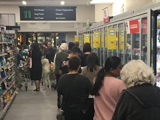 50-metre lines at Woolworths as coronavirus shopping panic escalates Credit: Twitter