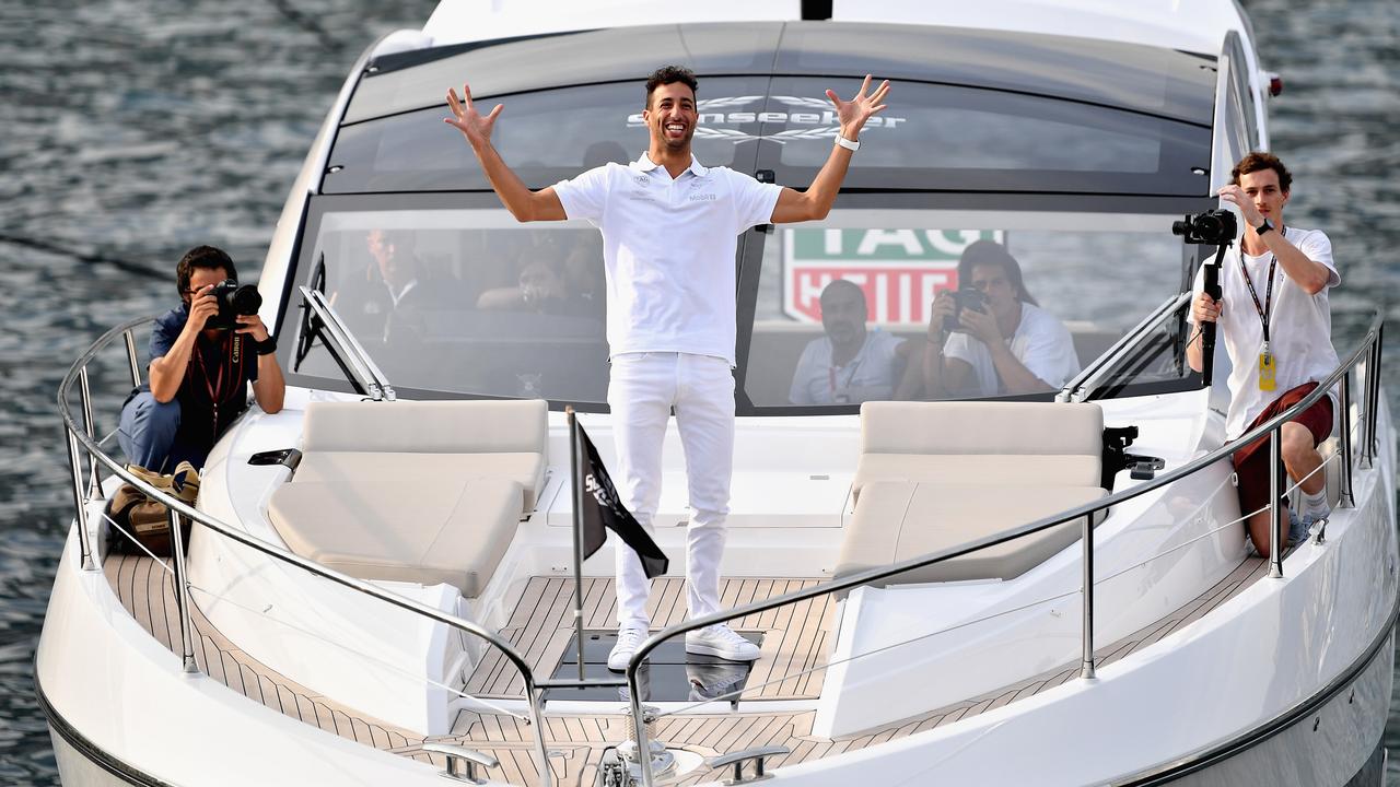 Ricciardo celebrates after catching a ball thrown by NFL star Tom Brady.