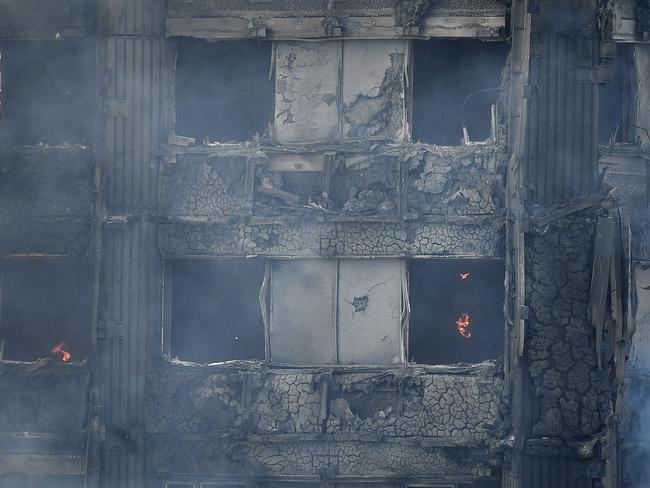 Flames still flicker inside the tower eight hours after fire started. Picture: Leon Neal/Getty Images