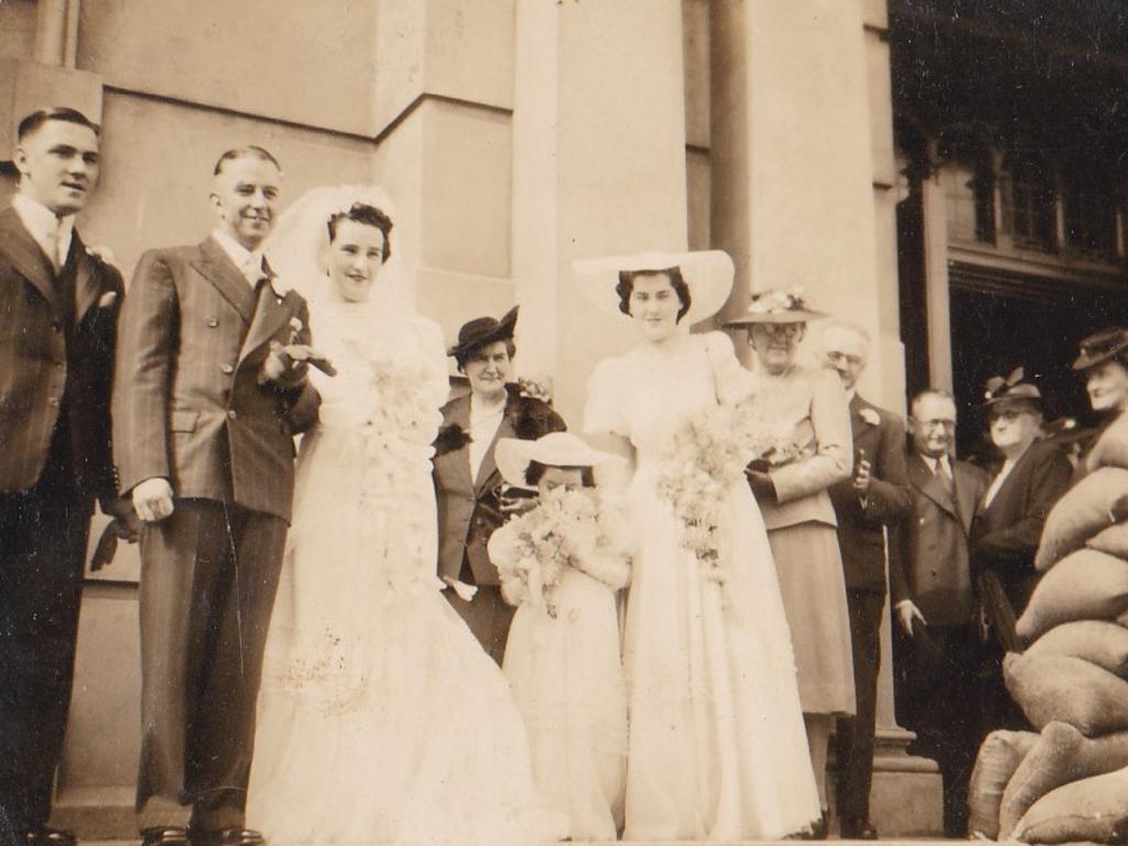 “A photo of my mother Noreen Scott as bridesmaid in 1942 to my Aunty Mary and Uncle Jack outside St Vincent’s Church, Ashfield. Note the sandbags at the front door.” Picture: Supplied by Adrian Neylan