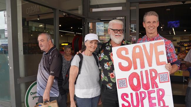 Parramatta federal Labor MP Andrew Charlton, right, with residents outside Pendle Hill Woolworths Metro after it announced it would shut.