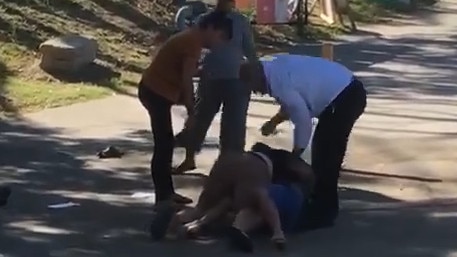 Footage has emerged of two men fighting on a footpath outside a polling booth in Redbank.