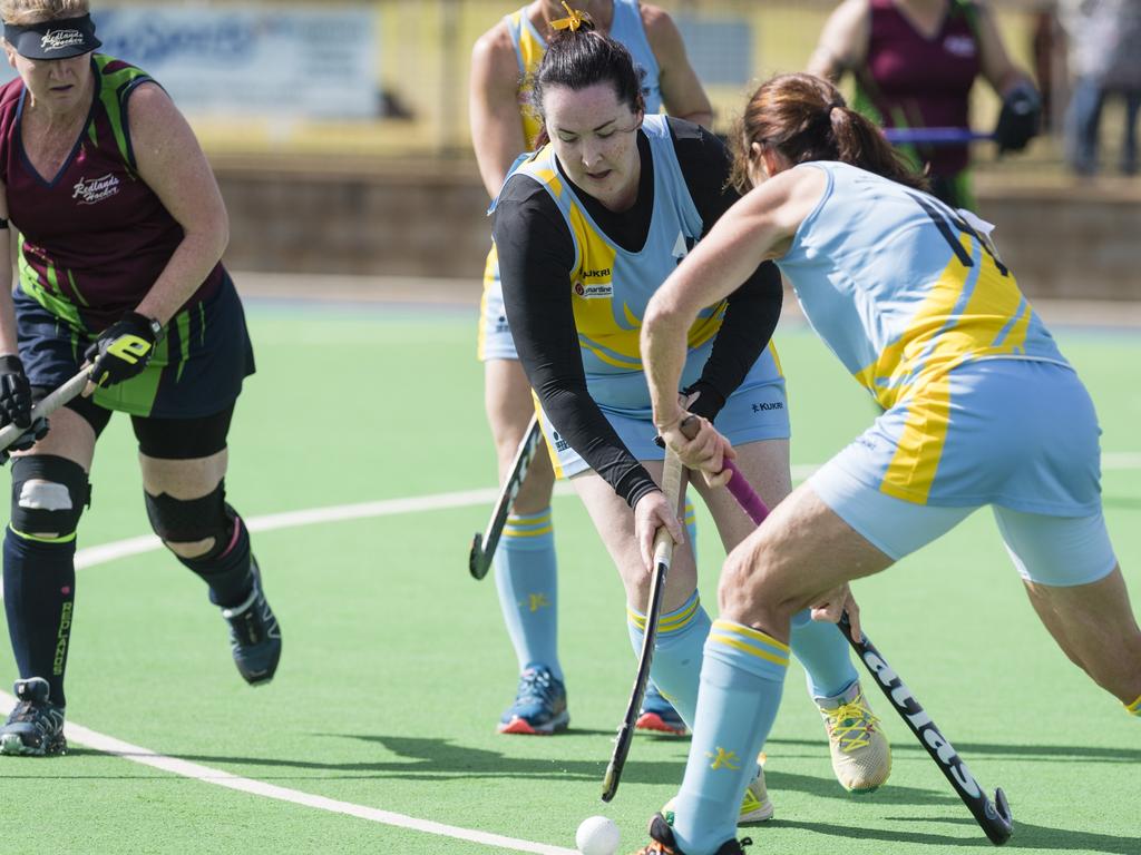 Melanie Craig (centre) of Cairns 1 against Redlands 1.