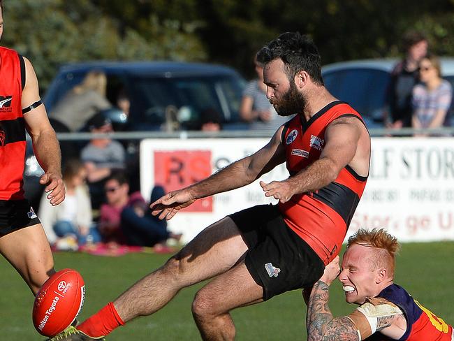 Romsey’s Cameron Streeter is brought down by Diggers Rest’s Mark Freeth. Picture: Carmelo Bazzano.