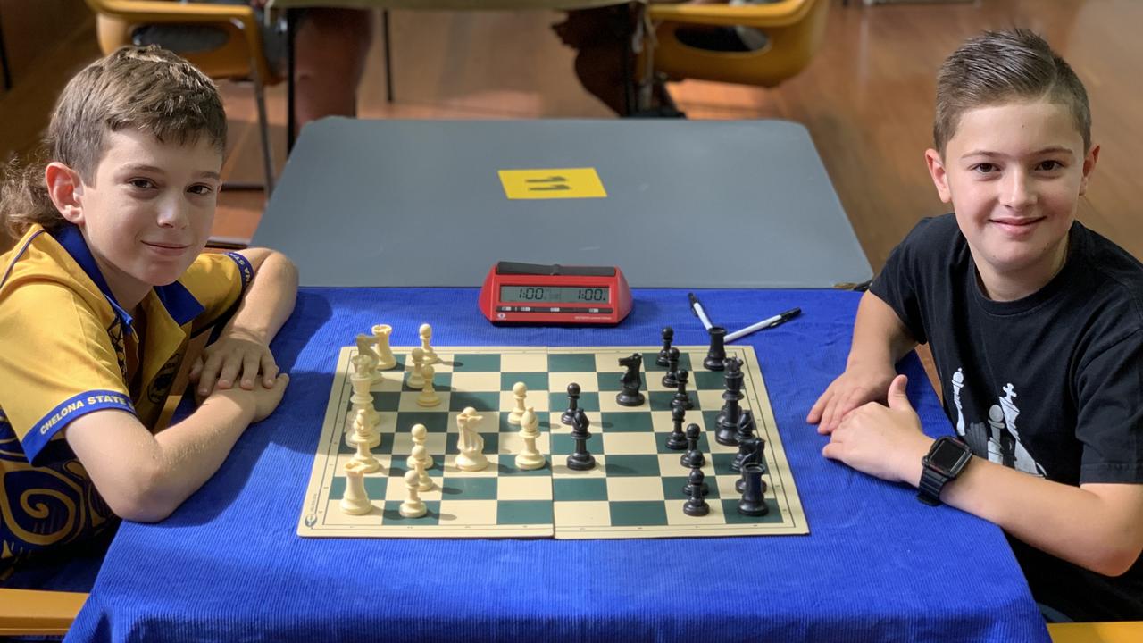 Chase Marshall (left) and Cruz Patroni warm up at the Mackay Chess Open on May 14. The Mackay Open was the first chess tournament for Chase and Cruz. In his first match, Chase said the long clock gave him more time to think about his moves. Chase played the white pieces and went with the London opening. Picture: Duncan Evans