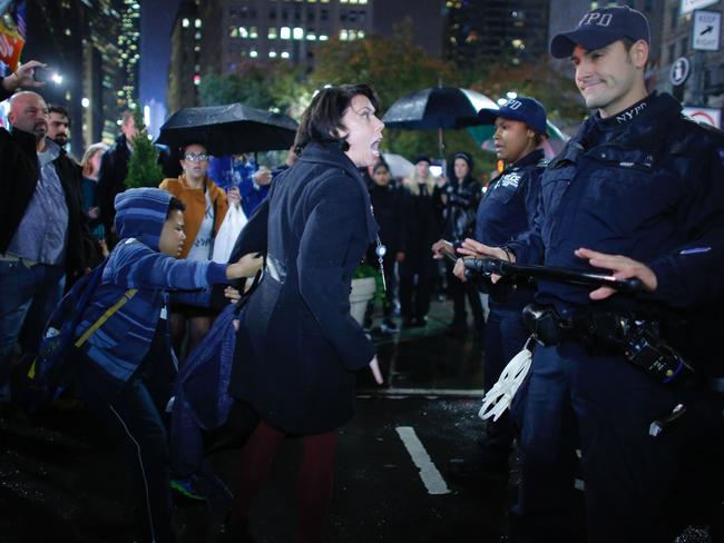 A woman argues with NYPD officers as she takes part in a protest against President-elect Donald Trump in New York City on November 9, 2016. Picture: AFP