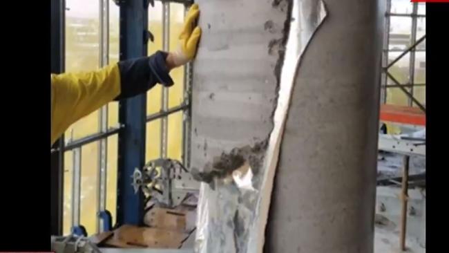 A concrete support pillar on the tenth floor is set with plastic sheet stuck inside of it.