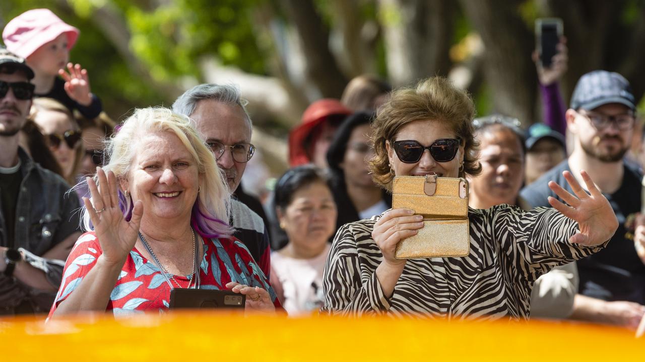 Brisbane visitors Sonja Potgieter (left) and Louise Notnagel react as a float drives past in the Grand Central Floral Parade of Carnival of Flowers 2022, Saturday, September 17, 2022. Picture: Kevin Farmer