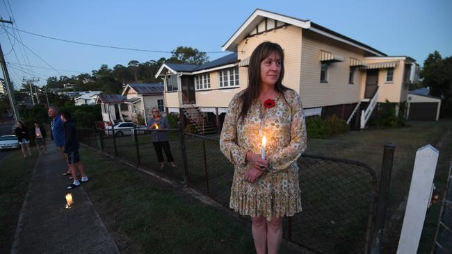 Tammy Concannon stands outside her home at dawn to commemorate Anzac Day in Brisbane, Saturday, April 25, 2019. Anzac Day is a national day of remembrance to commemorate the service and sacrifice of Australian and New Zealand service men and women. Due to COVID-19 restrictions marches and commemorative services have been banned for the first time in more than a century. (AAP Image/Dan Peled) NO ARCHIVING