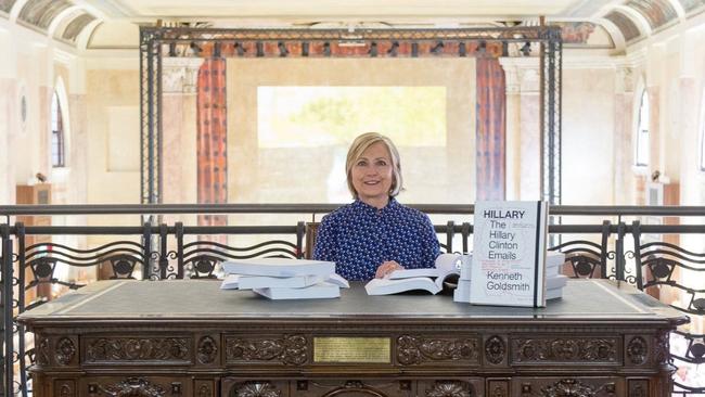 Hillary Clinton hams it up at an art installation reading her emails. Picture: Twitter / @HillaryClinton