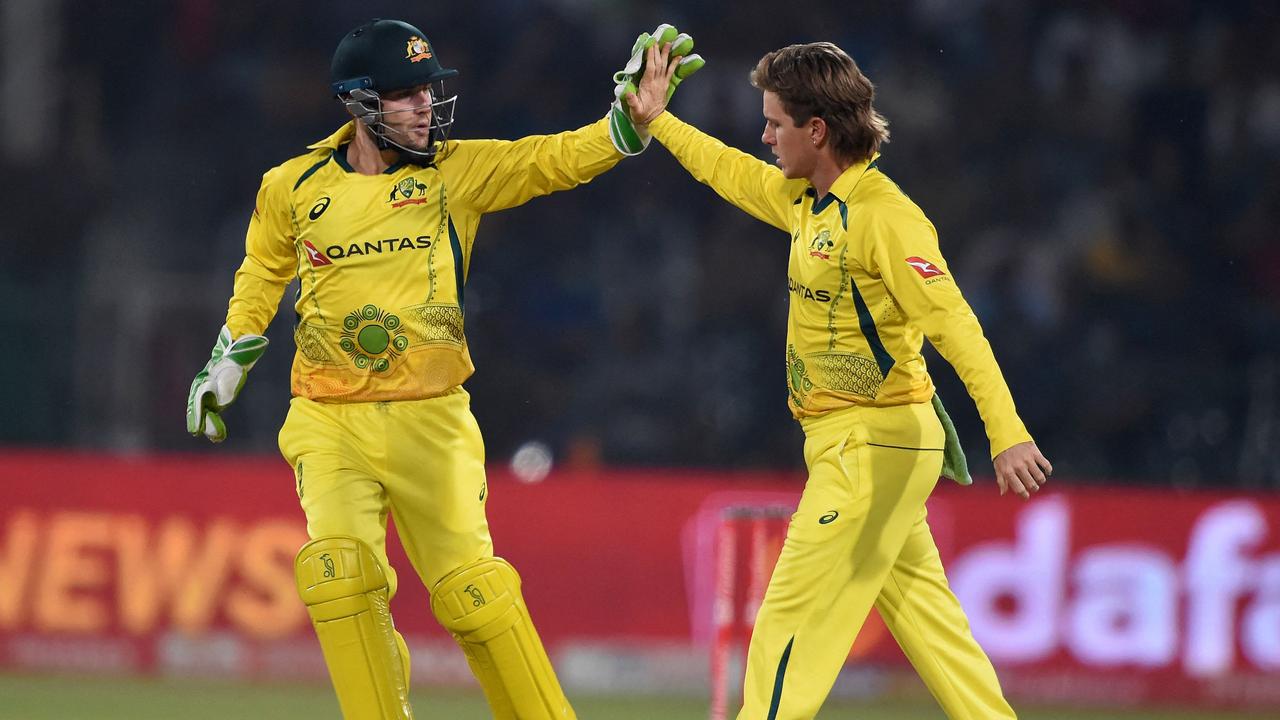 Adam Zampa celebrates with Josh Inglis after removing Babar Azam. Picture: AFP Images