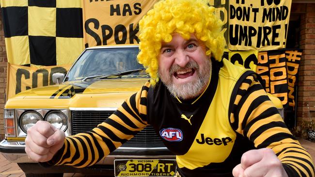 Tiger Army fan ‘Trout from Woodend’ (alias Brett Beattie) with his ‘yellow and black’ Holden. Picture: Jay Town