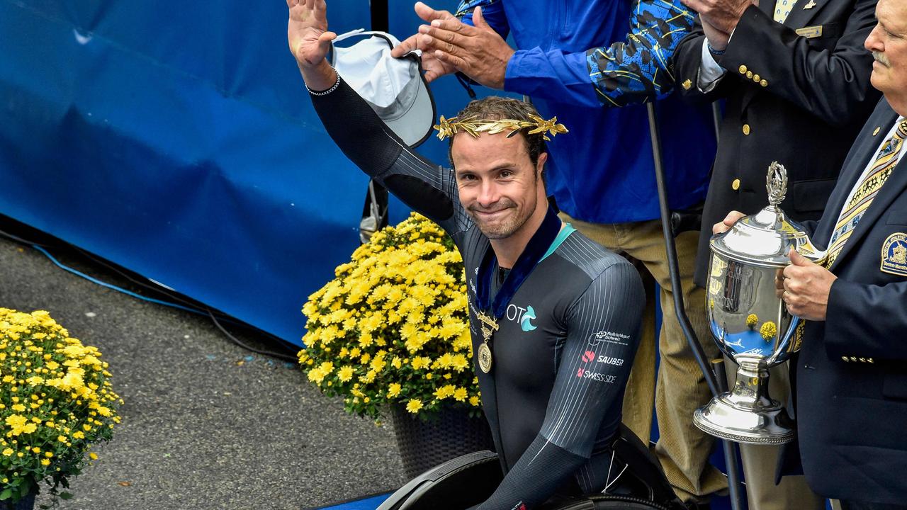 Marcel Hug waves after taking first place during the 125th Boston Marathon. Photo by JOSEPH PREZIOSO / AFP.