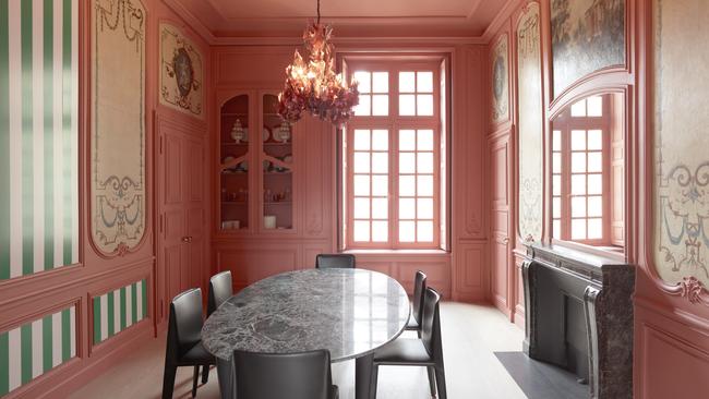 Clockwise from above, in the dining area, a contemporary wall installation by Daniel Buren sits alongside <i>Allegory of the Arts</i> - <i>Sculpture</i> and <i>Painting</i> canvases on woodwork above the north and south doors. Over the fireplace is a 400-year-old figurative work in canvas on plaster delicately restored at the Louvre. Picture: Tommaso Sartori