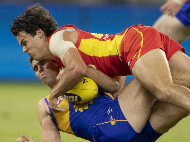 Gold Coast's Jack Bowes tackles West Coast's  Jamie Cripps during the Round 4 AFL match between the West Coast Eagles and the Gold Coast Suns at Optus Stadium in Perth, Saturday, April 14, 2018. (AAP Image/Travis Anderson) NO ARCHIVING, EDITORIAL USE ONLY