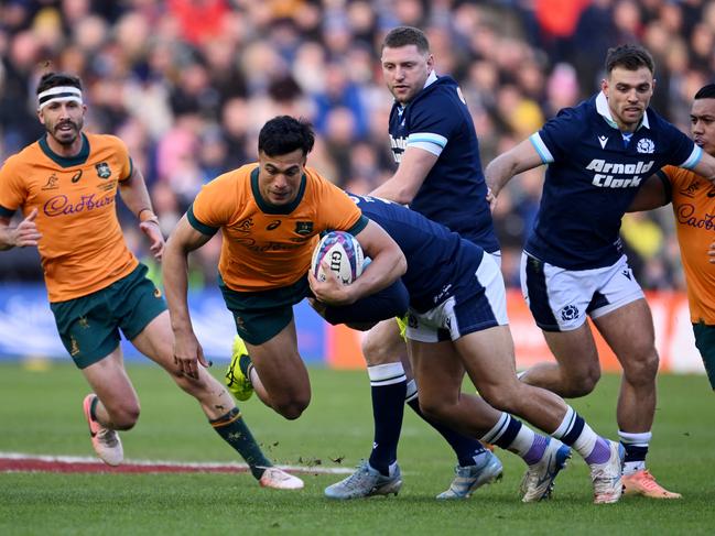 Joseph-Aukuso Suaalii is tackled by Scotland’s Sione Tuipulotu. Picture: Getty Images