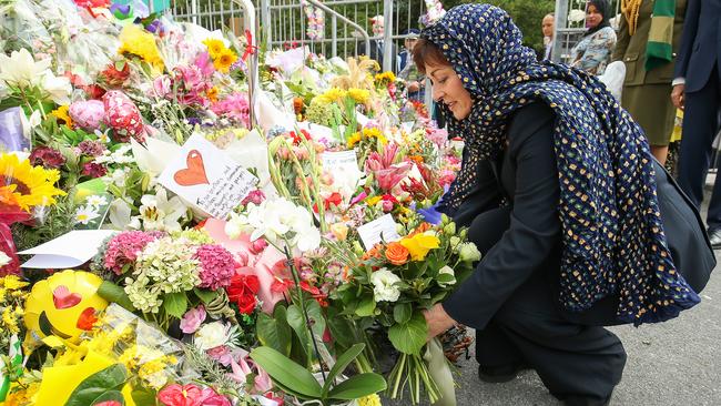 New Zealand Governor General Dame Patsy Reddy lays flowers on the steps of the Kilbirnie Mosque in memory of the victims of the Christchurch shooting attacks. Picture: Hagen Hopkins/Getty Images