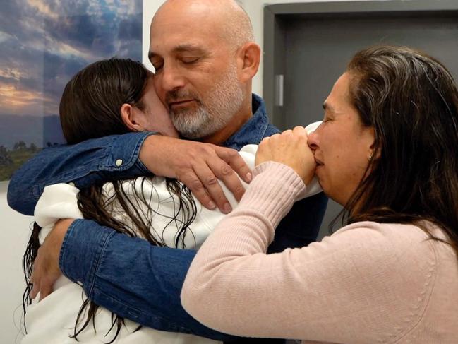 This handout picture released by the Israeli army shows former Israeli hostage Naama Levy reunited with family at an army screening point in Reim in southern Israel on January 25, 2025. Palestinian militants and Israel carried out a second hostage-prisoner swap on January 25 under the Gaza ceasefire deal, but a last-minute dispute blocked the expected return of hundreds of thousands of Palestinians to devastated northern Gaza. Four freed Israeli women hostages, all soldiers, arrived home in Israel after more than 15 months of captivity in the Palestinian territory. (Photo by Israeli Army / AFP) / === RESTRICTED TO EDITORIAL USE - MANDATORY CREDIT "AFP PHOTO / Handout / Israeli Army' - NO MARKETING NO ADVERTISING CAMPAIGNS - DISTRIBUTED AS A SERVICE TO CLIENTS ==