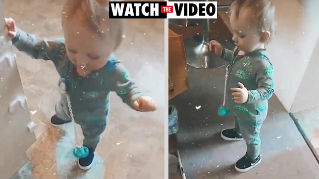 14-month-old Spencer Roberts tries out his new shoes