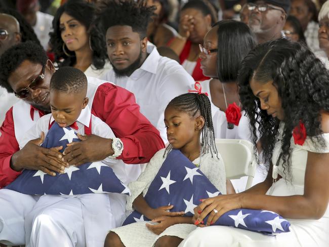 Richard Johnson Sr with La David Johnson Jr, Ah’Leesya Johnson, and Myeshia Johnson during the funeral. Picture: Mike Stocker/South Florida Sun-Sentinel/AP