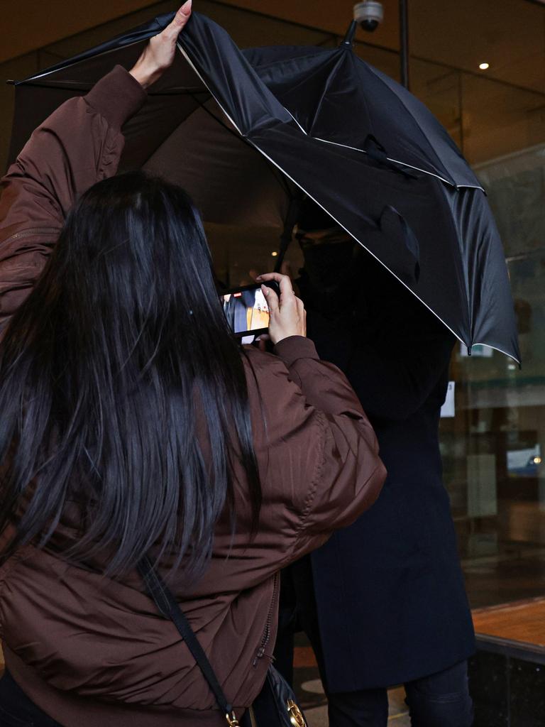 A scuffle erupted when the woman lifted the umbrella. Picture: Adam Yip