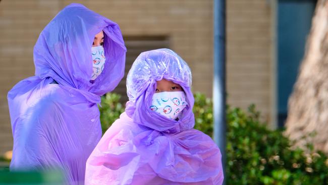 Quarantining hotel guests at the Holiday Inn near the Airport are evacuated to a new location in Melbourne on Wednesday. Picture: Luis Ascui/AAP