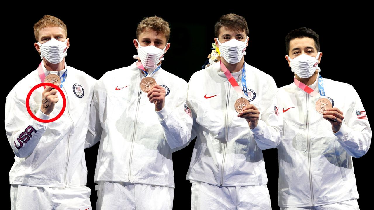 Race Imboden displayed an “X” on his hand in a “symbol of solidarity” for the medal ceremony. Picture: Elsa/Getty Images