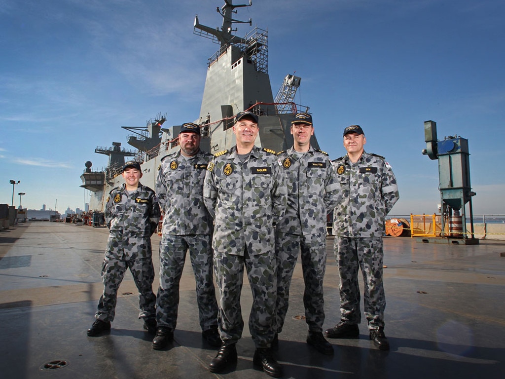 Navy crew members, AS Roma Scheepers, PO Steven Firkin, Ships Capt. Jonathan Sadleir, Commander Dave Walter and CPO James Dew on the top flight deck.