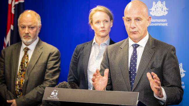 Pictured from left; Director of Public Health Mark Veitch, Minister for Health Sarah Courtney, and Tasmanian Premier Peter Gutwein. Mr Gutwein said the state had powers to fine anyone ignoring a directive from the Director of Public Health and may do so. Picture: News Corp