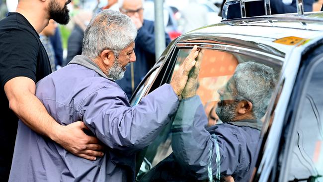 The father of murdered Sydney hairdresser Amy Hazouri grieves beside the hearse carrying the coffin. Picture: Jeremy Piper/NCA NewsWire