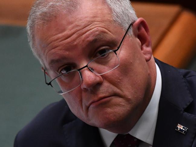 CANBERRA, AUSTRALIA - MARCH 17: Prime Minister Scott Morrison looks on during Question Time in the House of Representatives at Parliament House on March 17, 2021 in Canberra, Australia. Thousands of Australians marched at Ã¢â¬ÅMarch 4 JusticeÃ¢â¬Â rallies across Australia earlier this week, calling for action against gendered violence in Parliament, as news of the alleged rape of former Brittany Higgins at Parliament House and allegations that Attorney-General Christian Porter raped a 16-year-old girl when he was 17 in 1988 continue to cause outrage. (Photo by Sam Mooy/Getty Images)