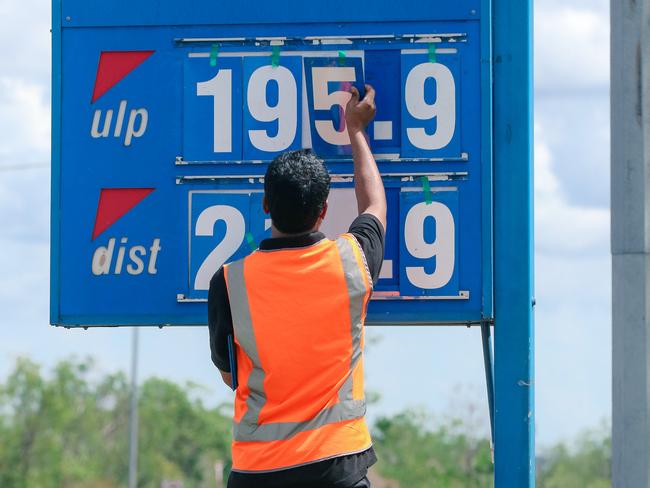 A service station worker adjusts fuel prices at Noonamah United. Picture: Glenn Campbell