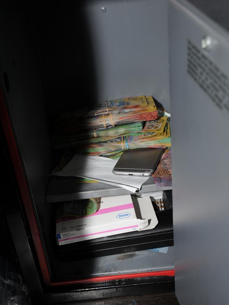 One of three safes located by police, this one in a bedroom contained more than $20,000 cash and an iPhone.