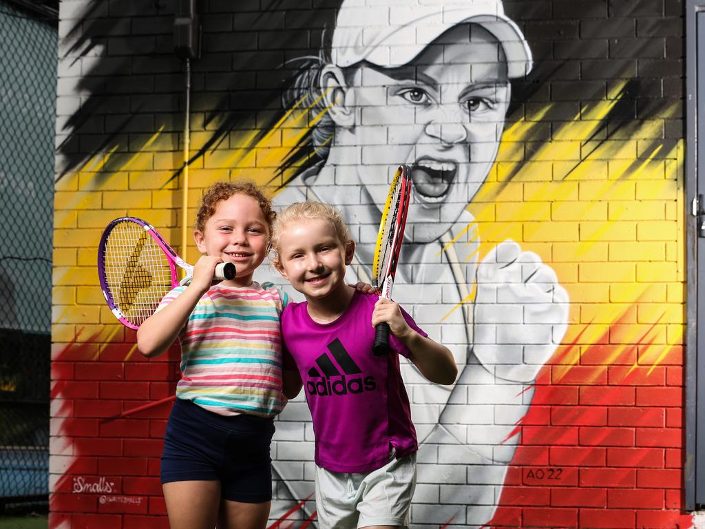 While she may be retiring, Barty will continue to inspire tennis hopefuls for years to come - like junior tennis players Isla Smith-Lester, 5 and Amelia Kingsnorth, 6, pictured in front of the Ash Barty mural at Pure Tennis in Ferny Hills. Picture: Zak Simmonds.