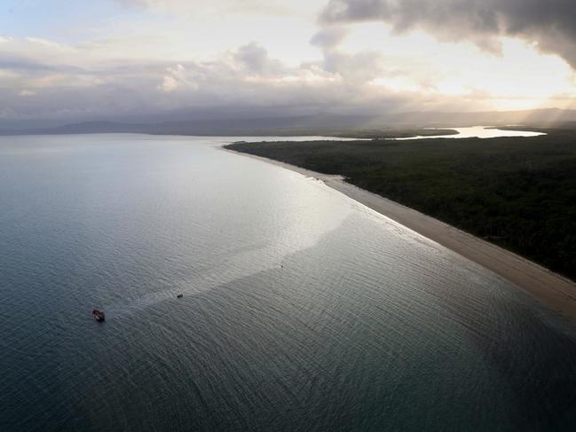 Workers attempt to stem the flow of diesel from a Vietnamese fishing boat, which sank off Cape Kimberley in North Queensland full of asylum seekers. Picture: Marc McCormack