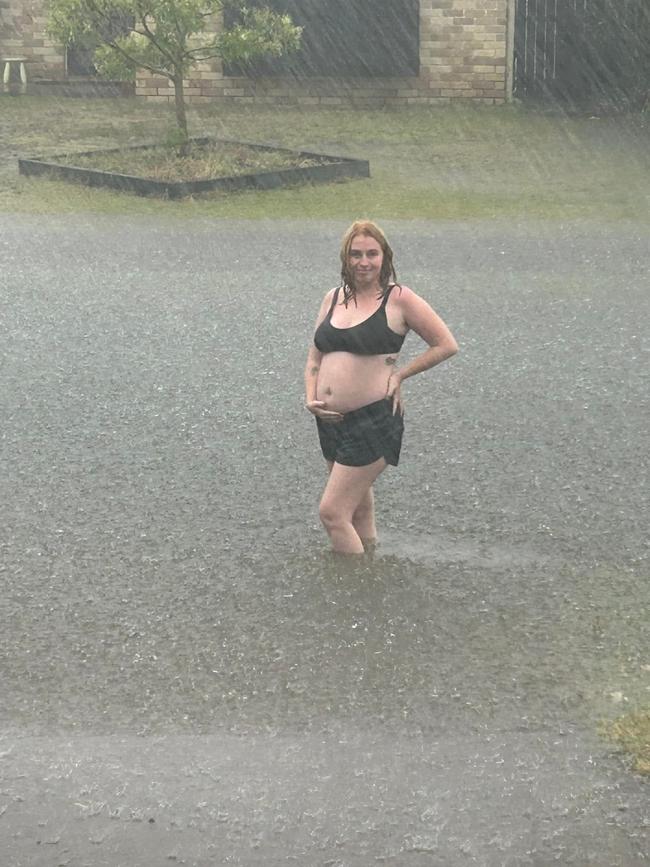 Jasmyne Pinkster of Eli Waters braves the rain amid the wild weather brought by ex-Tropical Cyclone Alfred.