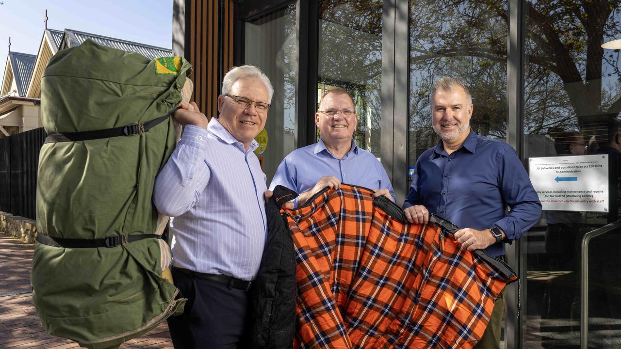 Mitsubishi Motors CEO Shaun Westcott, Hutt St Centre CEO Chris Burns and The Advertiser Foundation’s Dan Demaria with swags and sleeping bag that will be given to the homeless. Picture: Kelly Barnes