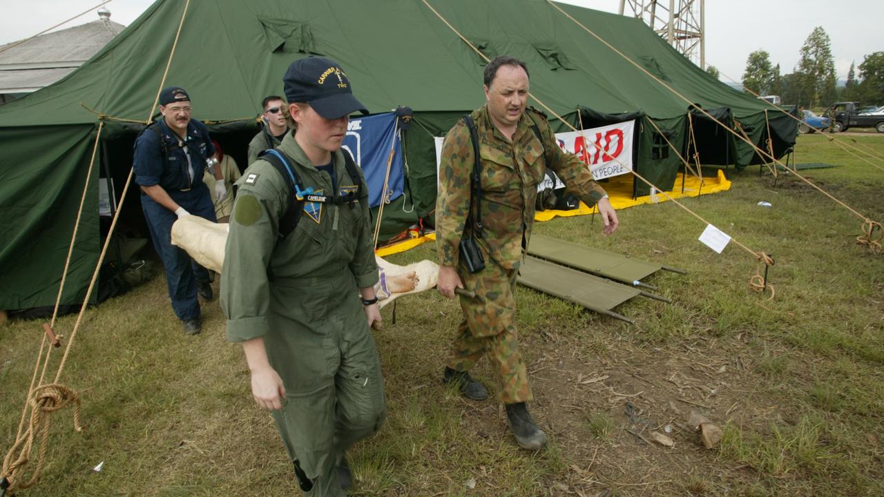 Dr Bill Griggs helps stretcher a patient