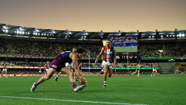 Brisbane’s Cam Rayner grabs the ball as the sun sets at the Gabba on Sunday with the finals-bound Lions defeating St Kilda. Picture: Getty Images