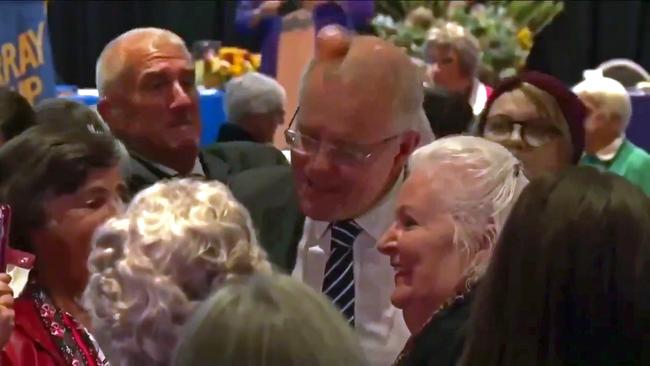 Prime Minister Scott Morrison is "egged" by an activist as he visits the Country Women's Association State Conference Picture: Seven News