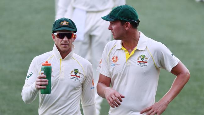 Australian captain Tim Paine (left) and paceman Josh Hazlewood talk tactics yesterday. Picture: AAP